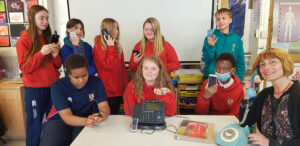 Lathallan pupils holding old telephones as part of art project with artist with Lada Wilson