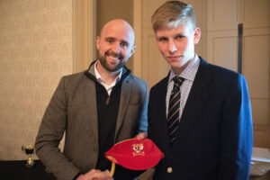 Lathallan pupil Adam Woodhouse receiving his red cap from Ross Campbell at Lathallan Sports Dinner 2022
