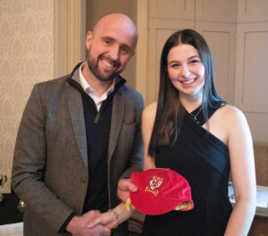 Lathallan pupil Ailsa Arbuthnott receiving her red cap from Ross Campbell at Lathallan Sports Dinner 2022